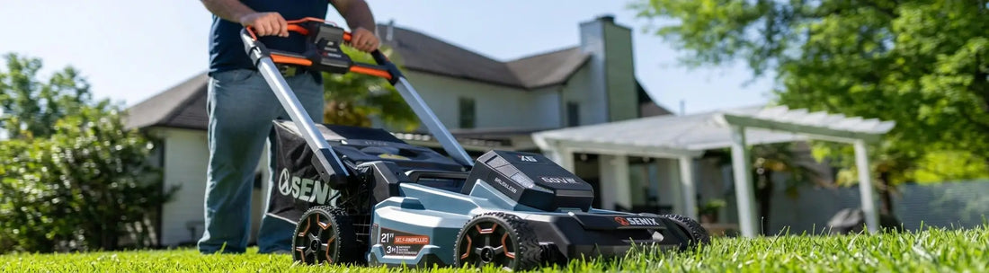 A close-up shot of a SENIX 60V blue cordless self-propelled lawn mower being operated on a green lawn by a house banner.